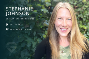 Stephanie Johnson, VP of Clinical Operations headshot wearing black sweater and army pattern shirt posing outside in front of some greenery with text overlay. Text: Stephanie Johnson, Location: California, 6+ years of service with our organization