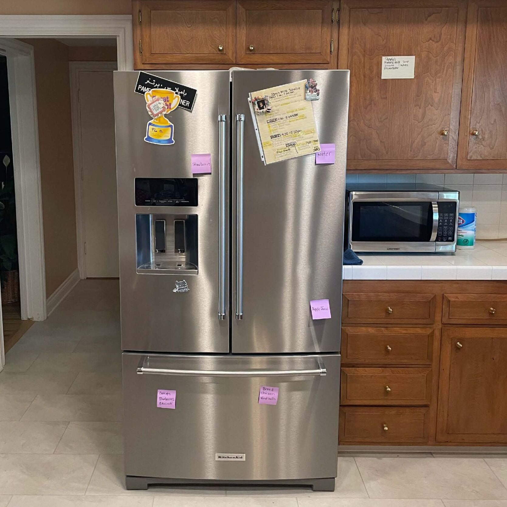 a stainless steel refrigerator and freezer in a kitchen